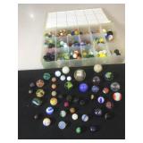 Full box of colorful marbles, ranging in
