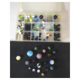 Full box of colorful marbles, ranging in