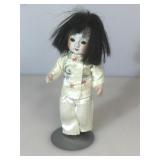 8 in. Japan bisque character doll with stand, vg