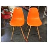 Pair of orange plastic barstools