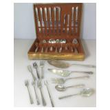 Assorted mix of plated flatware in wooden storage