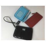 Three assorted Coach wristlets/wallets.
