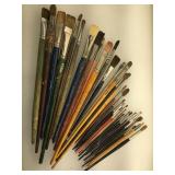 Group of used artist paint brushes and other