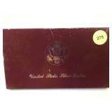 1983 Olympic Silver Dollar in box with info