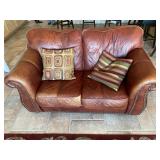 Leather Loveseat with 2 decorative pillows. 68in.