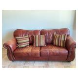 Leather Sofa with 3 decorative pillows. 86in.