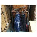 A PAIR OF GOLF BAGS WITH ASSORTED CLUBS