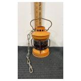 Orange railroad lantern with amber globe