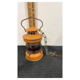 Orange railroad lantern with amber globe