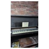 Vintage piano and stool in the basement