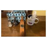 Metal dresser stand with three watches,