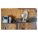 Shelf full of various items.  Finishing sander,