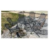 Outside metal table with 6 chairs.  4 that match