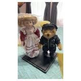 Porcelain doll and stand. And biker bear with