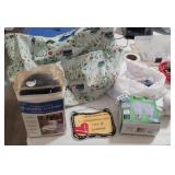 TABLE FULL: SIGNS, FOOT WARMERS, BAG, WEBCAM, BULB