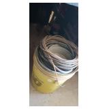 BUCKET FULL OF NAILS WITH WIRE ON TOP