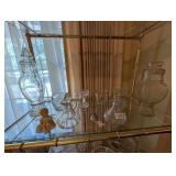 SHELF OF GLASS AND TRINKETS