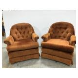 Pair of swiveling orange cushioned chairs