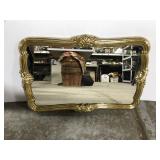 Small ornate gold framed wall mirror
