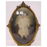 Antique metal framed oval child portrait