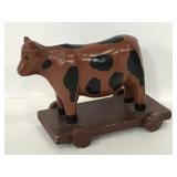 Vintage handcrafted wood cow on wheels toy