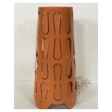 Orange metal table lamp with cutouts