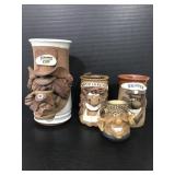 Four studio pottery face mugs
