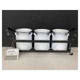 Mini metal milk cans in a stand