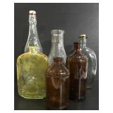 Six vintage glass bottles