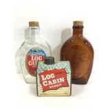 Two glass Log Cabin syrup bottles and 1 tin