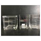 Three Lucite containers