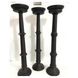 Trio of tall wood candle pillares