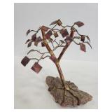 Metal tree sculpture on stone piece