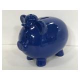 Dark blue ceramic piggy bank with baseball hat on