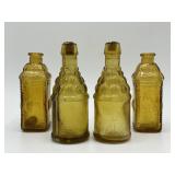 Four honey yellow miniature bottles
