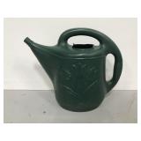 Green plastic watering can