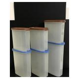 Six tall skinny Tupperware containers