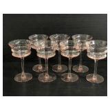 Seven pink depression glass stemmed glasses