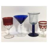 Four assorted colored glass goblets