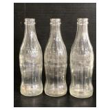 Trio of glass Coca-Cola bottles