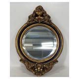 Ornate round gold framed wall mirror