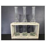 Three glass bottle is wood holder