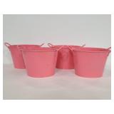 Four pink metal planters or baskets
