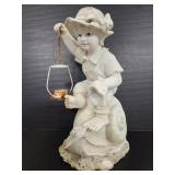 Resin garden statue of boy on snail with lantern