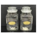 Two glass canisters with lids