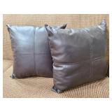 Two faux leather throw pillows