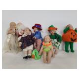 Seven small holiday dresses porcelain dolls