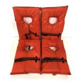 Four bright orange adult life jackets
