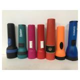 Seven plastic assorted flashlights