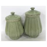Two matching ceramic light green canisters